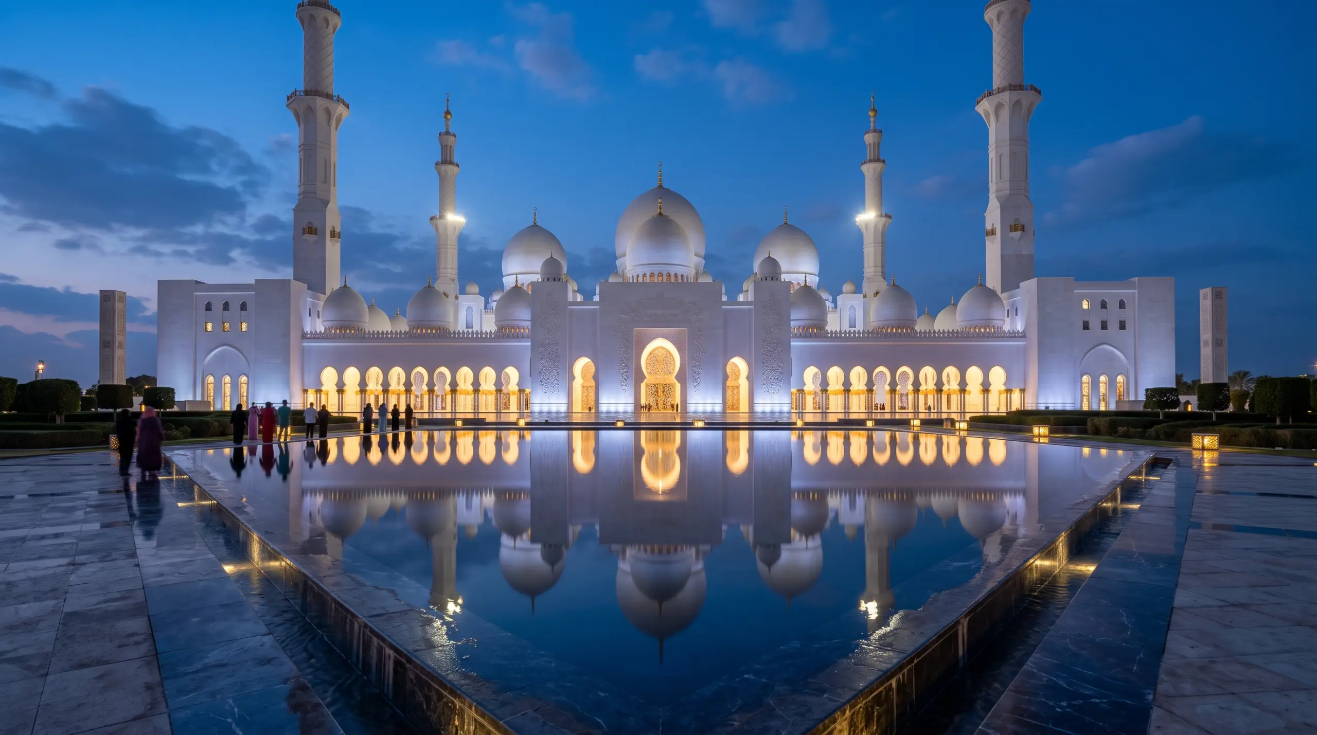 Sheikh Zayed Grand Mosque in Abu Dhabi at blue hour, mirrored in its reflecting pools