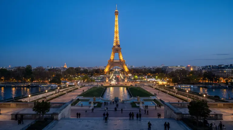 The Eiffel Tower at blue hour seen from the Trocadéro, with lights along the Seine