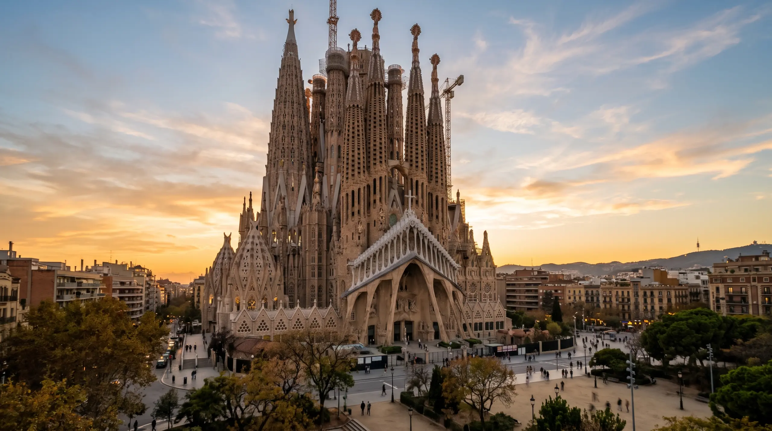 Barcelona's Sagrada Família at golden hour, its spires against a warm evening sky