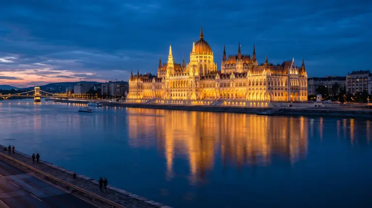 The Hungarian Parliament Building lit up on the Danube in Budapest at blue hour, reflected in the river